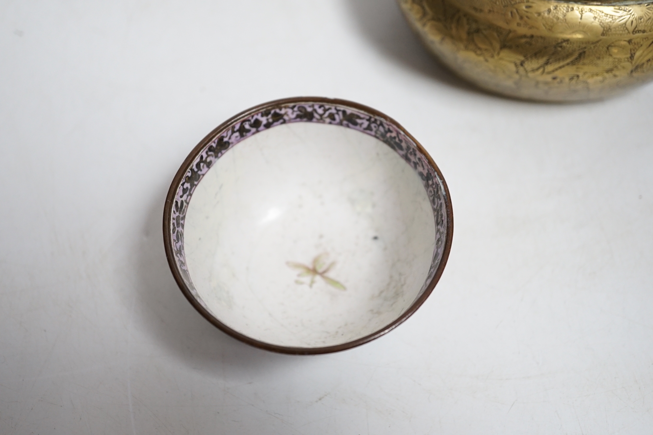 A Chinese bronze hand warmer, 11.3cm and an 18th century Chinese Canton enamel cup, cup 7cm diameter